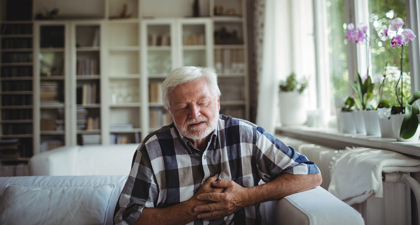 an older man with his hands over his heart